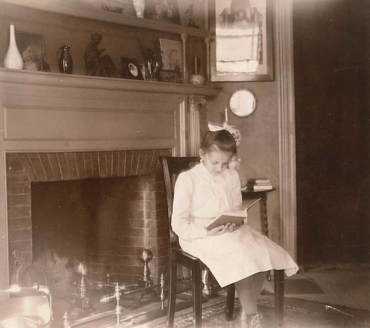 A young Emily Hale reading a book, ca. 1890s.